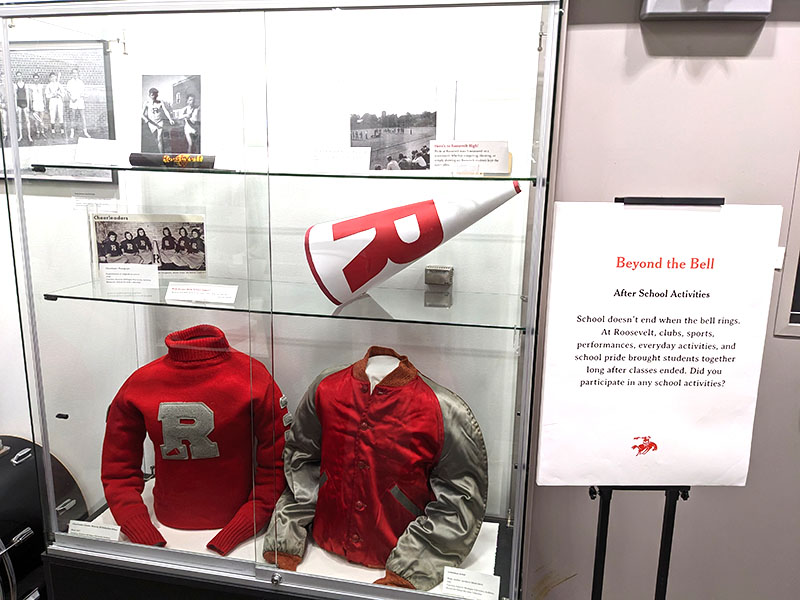 Photo of a display case containing a Roosevelt cheerleader's sweater jacket